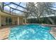 A screened-in pool with a waterfall feature, creating a backyard oasis for relaxation and enjoyment at 1657 Cherry Ridge Dr, Lake Mary, FL 32746