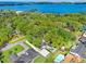 Aerial view of a beautiful home nestled among lush trees with lake views in the background at 1804 Wind Willow Rd, Belle Isle, FL 32809