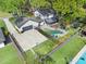 Aerial view of the home with a pool, screened-in porch, detached garage, and manicured lawn at 1804 Wind Willow Rd, Belle Isle, FL 32809