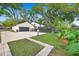 Fenced backyard with a large driveway and lush green lawn at 1804 Wind Willow Rd, Belle Isle, FL 32809