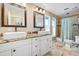 Bright bathroom featuring double sinks, granite counters, a shower and tiled floors at 1804 Wind Willow Rd, Belle Isle, FL 32809