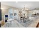 Elegant dining room with stylish light fixture, large windows, and easy access to the kitchen at 1804 Wind Willow Rd, Belle Isle, FL 32809