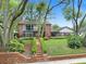 Charming two-story brick home featuring a lush front yard and inviting balcony at 1804 Wind Willow Rd, Belle Isle, FL 32809