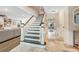 Inviting foyer with beautiful tile flooring and a staircase leading to the upper level at 1804 Wind Willow Rd, Belle Isle, FL 32809