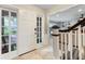 Bright foyer featuring tiled floors with a view of the staircase and living area at 1804 Wind Willow Rd, Belle Isle, FL 32809