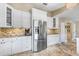 Modern kitchen with stainless steel appliances, white cabinetry, and granite countertops at 1804 Wind Willow Rd, Belle Isle, FL 32809