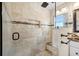 Elegant walk-in shower with travertine tile, a built-in niche, and a frameless glass enclosure at 1804 Wind Willow Rd, Belle Isle, FL 32809