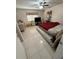 Simple bedroom with tiled floors, dresser, tv, and natural light from the window at 1808 4Th Se Ct, Winter Haven, FL 33880