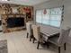 Dining room with tiled floors featuring a stone accent wall and large window at 1808 4Th Se Ct, Winter Haven, FL 33880