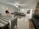 Bright living room with a gray sofa, tile floors, and a decorative fireplace, creating a cozy and inviting space at 1808 4Th Se Ct, Winter Haven, FL 33880