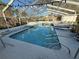 Enclosed pool area with a sparkling in-ground pool, surrounded by lush landscaping and a serene outdoor space at 1808 4Th Se Ct, Winter Haven, FL 33880