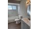 Well-lit bathroom featuring marble tile surround, new fixtures, and a modern vanity sink at 1845 Portview Ave, Deltona, FL 32738