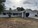 Charming single-story home featuring a white painted facade, two-car garage, and neatly kept front yard at 1845 Portview Ave, Deltona, FL 32738