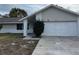 A well-maintained single-story home with attached garage, a welcoming front porch, and tidy landscaping at 1845 Portview Ave, Deltona, FL 32738