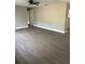 Spacious living room featuring modern wood-look floors, a ceiling fan and neutral paint at 1845 Portview Ave, Deltona, FL 32738