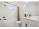 Modern bathroom featuring white subway tile, a tub-shower combo, and a stylish vanity at 19307 Banfield Pl, Orlando, FL 32827