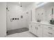 Beautiful bathroom showcasing a glass-enclosed shower with rainfall shower head, black fixtures and dual sink vanity at 19307 Banfield Pl, Orlando, FL 32827