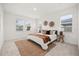 Brightly lit bedroom featuring a queen size bed, neutral carpet, and 3 large windows at 19307 Banfield Pl, Orlando, FL 32827