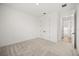 Spacious bedroom with plush carpeting, double closets, and an ensuite bathroom at 19307 Banfield Pl, Orlando, FL 32827