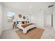 Neutral bedroom with cozy rug features a queen-size bed and soft, natural light from two windows at 19307 Banfield Pl, Orlando, FL 32827