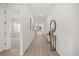 Hallway with light floors, console table, decor, and an open view to living spaces at 19307 Banfield Pl, Orlando, FL 32827