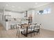 Kitchen and dining area featuring modern appliances, a stylish island with a breakfast bar, and a dining table at 19307 Banfield Pl, Orlando, FL 32827