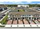 A high aerial view of a community showcasing townhomes with brick driveways and garages at 208 Cape Honeysuckle Pl, Sanford, FL 32771