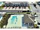 Overhead view of community pool and clubhouse with ample seating and nearby townhomes at 208 Cape Honeysuckle Pl, Sanford, FL 32771