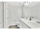 Bathroom featuring a double sink vanity, modern fixtures, and a clean, minimalist design at 208 Cape Honeysuckle Pl, Sanford, FL 32771