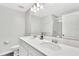 Bright bathroom with double sink vanity, modern mirror, and a shower with glass door at 208 Cape Honeysuckle Pl, Sanford, FL 32771