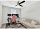 Bright bedroom features a ceiling fan, a large window, and is set up as a home office at 208 Cape Honeysuckle Pl, Sanford, FL 32771