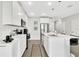 Bright kitchen with white cabinets, stainless steel appliances, and a breakfast bar at 208 Cape Honeysuckle Pl, Sanford, FL 32771