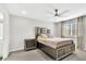 Serene bedroom with neutral decor, plush carpet, and a contemporary bed frame at 208 Cape Honeysuckle Pl, Sanford, FL 32771