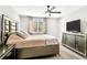 Cozy bedroom featuring a large bed, neutral walls, and a view from the window at 208 Cape Honeysuckle Pl, Sanford, FL 32771