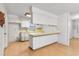 Bright kitchen with white cabinetry, laminate countertops, and breakfast bar area at 257 Sheppard St, Altamonte Springs, FL 32701