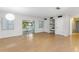 Spacious living room featuring wood floors, natural light, built in shelves and access to the back porch at 257 Sheppard St, Altamonte Springs, FL 32701