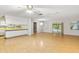 Bright living room featuring wood floors, neutral colors, and access to kitchen and outdoor area at 257 Sheppard St, Altamonte Springs, FL 32701