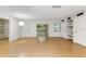 Spacious living room featuring wood floors, natural light, built in shelves and access to the back porch at 257 Sheppard St, Altamonte Springs, FL 32701