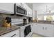 Modern kitchen with white cabinets, stainless steel microwave, and ample counter space at 3133 Yellow Lantana Ln, Kissimmee, FL 34747