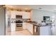 Bright kitchen featuring stainless steel appliances, white cabinetry, and a view of the backyard at 3154 Partington Blvd, Davenport, FL 33837