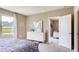 Well-lit main bedroom with carpet floors, a dresser, and a bright window with sheer curtains at 3154 Partington Blvd, Davenport, FL 33837