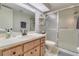 Cozy bathroom featuring a shower, wood-finish cabinets and tiled floor at 3467 Flossmoor Ave # 101, Orlando, FL 32822