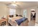 Bedroom featuring natural light, a ceiling fan, and an en suite bathroom at 3467 Flossmoor Ave # 101, Orlando, FL 32822