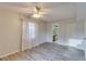 Comfortable main bedroom with wood-look floors, a ceiling fan, and ensuite bathroom at 3467 Flossmoor Ave # 101, Orlando, FL 32822