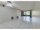 Bright living room featuring tile flooring and a ceiling fan, leading to a screened lanai at 3467 Flossmoor Ave # 101, Orlando, FL 32822