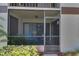 Screened patio with blue chairs and table, perfect for outdoor relaxation at 3467 Flossmoor Ave # 101, Orlando, FL 32822