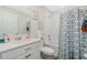 Bright bathroom featuring a tiled shower/tub, single vanity sink, framed artwork, and modern fixtures at 3920 Guernsey Bnd, St Cloud, FL 34772