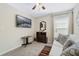 Bedroom featuring a mounted television, dresser, mirror, and a comfortable sofa with decorative pillows at 3920 Guernsey Bnd, St Cloud, FL 34772