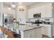 Bright kitchen features stainless steel appliances, grey countertops and a large center island with bar stool seating at 3920 Guernsey Bnd, St Cloud, FL 34772