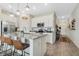 Modern kitchen with stainless steel appliances, a gray countertop island, and white cabinets at 3920 Guernsey Bnd, St Cloud, FL 34772